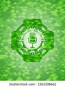 microphone icon inside realistic green mosaic emblem