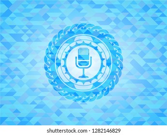 microphone icon inside realistic sky blue mosaic emblem