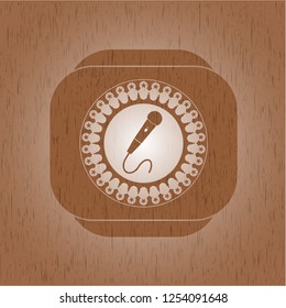 microphone icon inside realistic wooden emblem