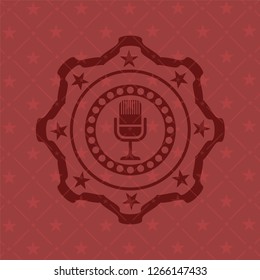 microphone icon inside red icon or emblem