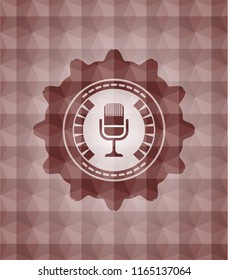 microphone icon inside red seamless emblem or badge with abstract geometric polygonal pattern background.