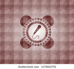 microphone icon inside red seamless emblem with geometric pattern.