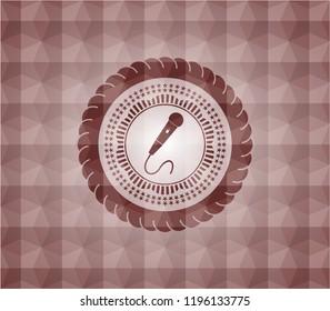 microphone icon inside red seamless emblem or badge with abstract geometric polygonal pattern background.