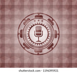 microphone icon inside red seamless emblem with geometric pattern background.