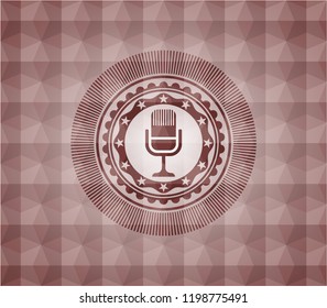 microphone icon inside red seamless emblem with geometric background.