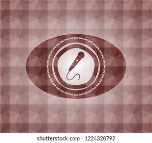 microphone icon inside red seamless emblem with geometric pattern background.
