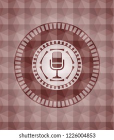 microphone icon inside red seamless emblem with geometric pattern background.