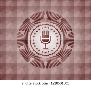 microphone icon inside red seamless polygonal badge.