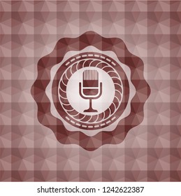 microphone icon inside red seamless emblem with geometric pattern background.