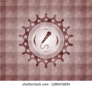 microphone icon inside red seamless emblem with geometric background.