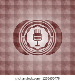microphone icon inside red seamless emblem with geometric pattern background.