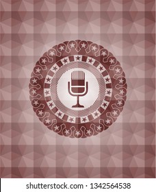 microphone icon inside red seamless emblem or badge with abstract geometric polygonal pattern background.