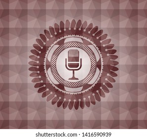 microphone icon inside red seamless emblem with geometric pattern.