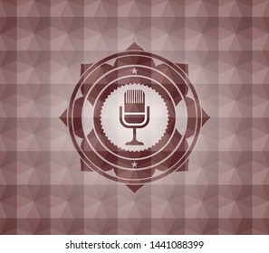 microphone icon inside red seamless emblem with geometric pattern background.
