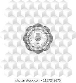 microphone icon inside retro style grey emblem with geometric cube white background