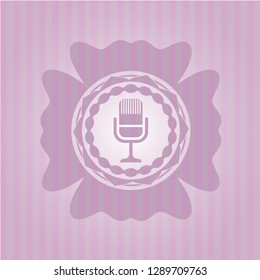 microphone icon inside retro style pink emblem