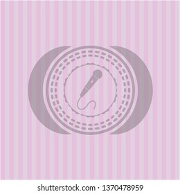microphone icon inside retro style pink emblem