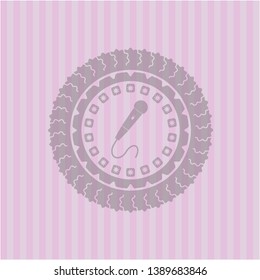 microphone icon inside retro style pink emblem