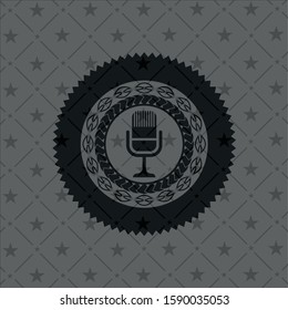 microphone icon inside retro style black emblem