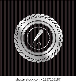 microphone icon inside silver badge