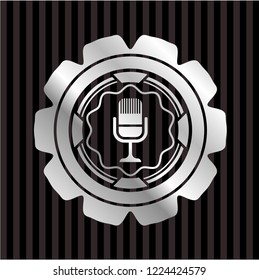 microphone icon inside silver emblem or badge