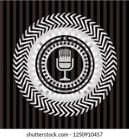 microphone icon inside silver emblem or badge
