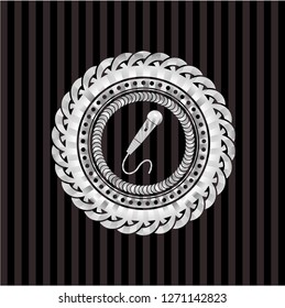 microphone icon inside silver emblem