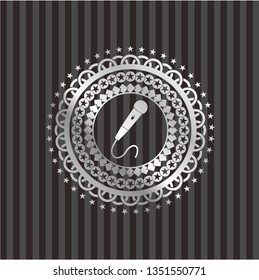 microphone icon inside silver emblem