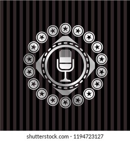 microphone icon inside silvery badge