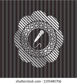 microphone icon inside silvery badge or emblem