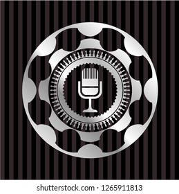 microphone icon inside silvery badge