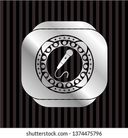microphone icon inside silvery badge or emblem