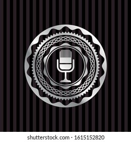 microphone icon inside silvery badge