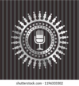 microphone icon inside silvery emblem or badge