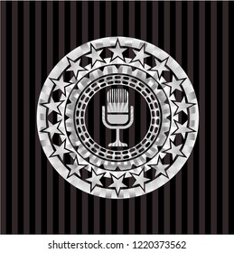 microphone icon inside silvery emblem