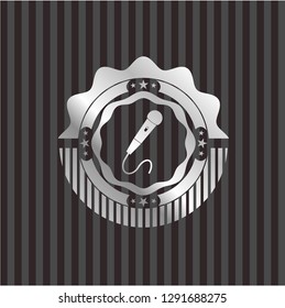 microphone icon inside silvery emblem
