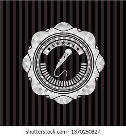 microphone icon inside silvery emblem