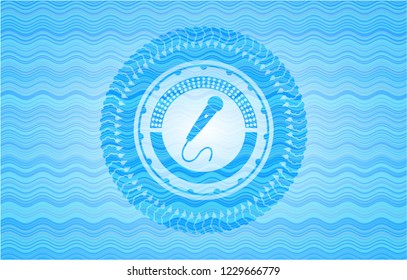 microphone icon inside sky blue water wave style emblem.