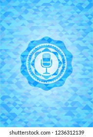 microphone icon inside sky blue emblem with mosaic background