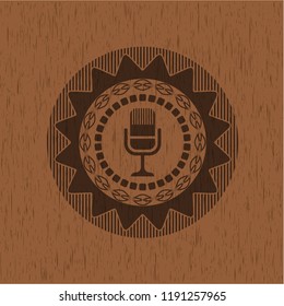 microphone icon inside vintage wood emblem