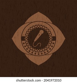 microphone icon inside vintage wood emblem. 
