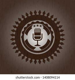 microphone icon inside vintage wooden emblem