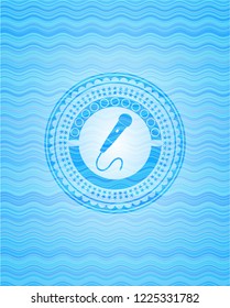 microphone icon inside water concept badge.