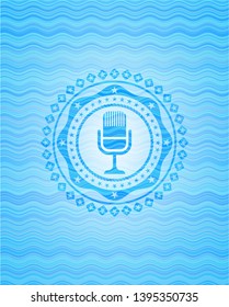 microphone icon inside water concept emblem background.