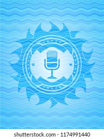 microphone icon inside water style badge.