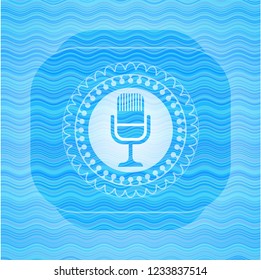 microphone icon inside water wave representation emblem.