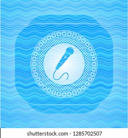 microphone icon inside water wave concept badge.