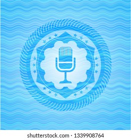 microphone icon inside water wave badge background.