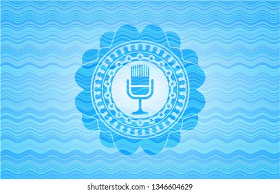 microphone icon inside water wave badge background.