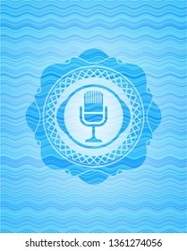 microphone icon inside water wave emblem.